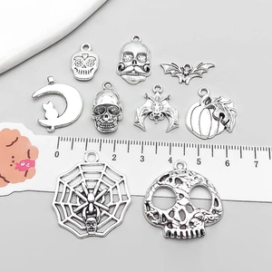 Antique silver Halloween charms set featuring skull, spider web and pumpkin pendants