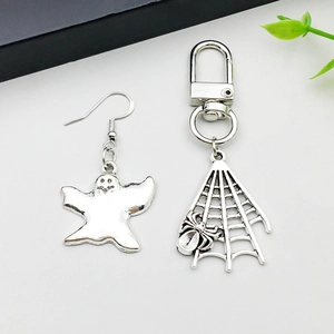 Detail of silver alloy Halloween jewelry set featuring ghost earring and spider web keychain