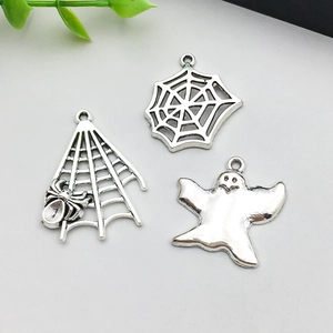 Detail of silver alloy Halloween charms featuring spider web and ghost for DIY jewelry