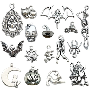 Set of 15 vintage silver Halloween charms including bat, spider web, and pumpkin pendants