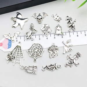 Antique silver Halloween charms assortment with ghost and bat on white background