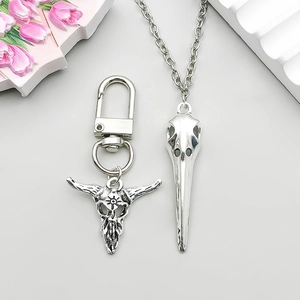 Macro shot of antique silver bull and bird skull gothic pendants for DIY jewelry