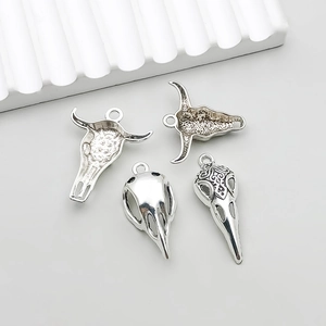 Set of four antique silver animal skull pendants for DIY jewelry making and crafts