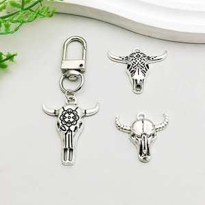 Macro detail of antique silver bull skull pendants with intricate tribal floral textures