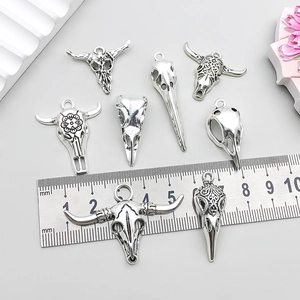 Vintage silver animal skull pendants including bull and bird skulls for DIY jewelry making