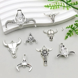 Detailed close-up of retro silver bull skull charms for DIY jewelry and accessories