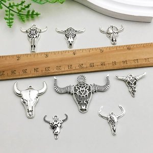 Set of 8 vintage silver bull skull pendants with tribal carvings for DIY jewelry making