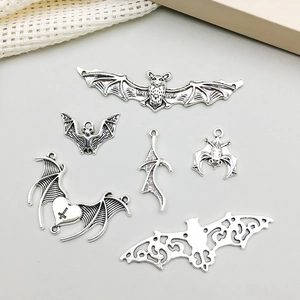 Detailed view of six vintage silver bat charms for DIY jewelry making and crafts