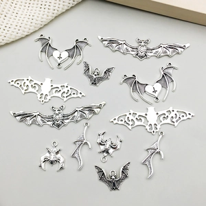 Detailed view of assorted antique silver bat charms with intricate textures for DIY jewelry