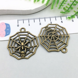 Detailed macro of antique bronze spider web alloy pendants for DIY jewelry making