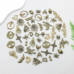 Detailed flat lay of 51 vintage bronze Halloween alloy pendants for DIY jewelry making