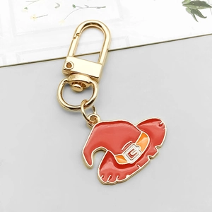 Close-up of a red enamel witch hat charm with gold alloy carabiner for Halloween DIY