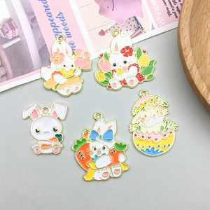 Detail of colorful enamel Easter bunny alloy pendants with floral and carrot designs for DIY