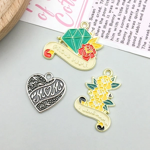 Macro view of Mother's Day alloy charms including Proud Mama heart and rose pendants