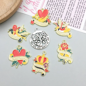 Detailed view of colorful enamel Mother's Day charms with heart and flower designs