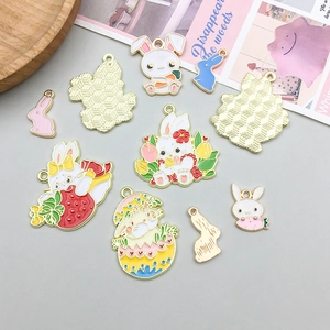 Flat lay of colorful enamel bunny charms with carrot and egg designs for DIY jewelry