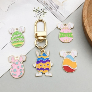 Detail of colorful Easter egg alloy charms with rabbit ears and golden keychain ring
