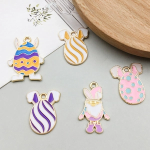 Detailed close-up of colorful enamel Easter egg charms with bunny ears for DIY jewelry