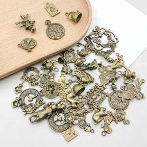 Detailopname van vintage bronzen Alice in Wonderland bedeltjes op een houten dienblad
