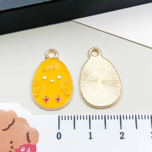 Front and back detail of a yellow enamel chick pendant for DIY jewelry making