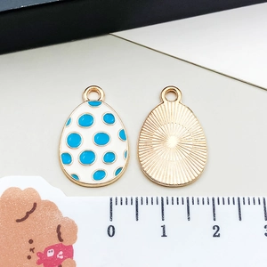 Front and back detail of enamel Easter egg pendant with blue dots and sunburst texture
