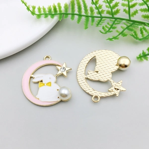 Detail of Easter bunny moon pendants with enamel finish and imitation pearls for jewelry