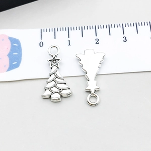 Macro detail of antique silver Christmas tree pendants with star top and measurement scale