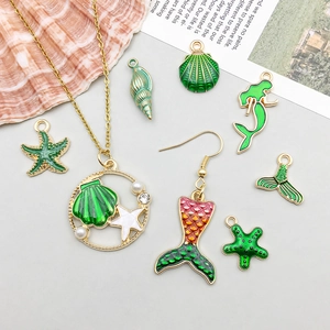 Macro shot of green enamel sea shell and starfish alloy pendants for DIY jewelry making