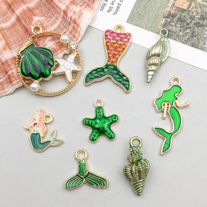 Detailed close-up of colorful ocean charms with shell, starfish and mermaid tail designs