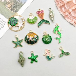 Detailed set of sea shell pendants with green enamel and gold finish for DIY jewelry