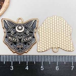 Detailed view of Halloween cat pendant with black enamel finish and moon star pattern