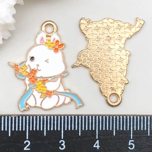 Detailed close-up showing front white enamel rabbit charm and golden textured back