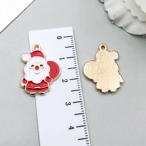 Detail of Santa Claus enamel alloy pendant with metal texture and top ring for DIY jewelry