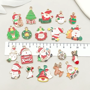 Christmas alloy enamel charms set with Santa, snowman, and reindeer on a grey background