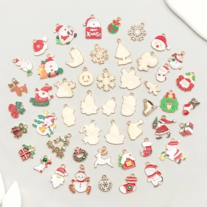 Flat lay of colorful Christmas alloy enamel charms including Santa, snowmen and reindeer