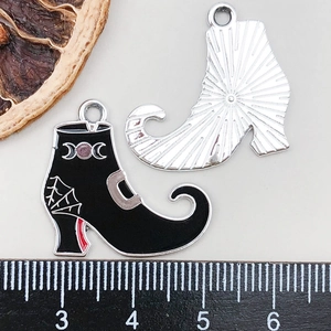 Detail of Halloween witch boot charms with spider web and moon patterns for DIY jewelry