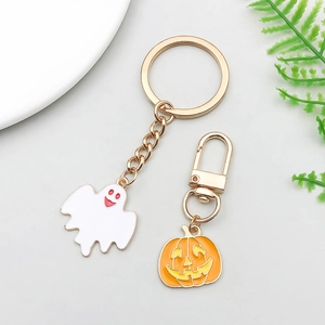 Detail of Halloween ghost and pumpkin charms with gold keychain and lobster clasp