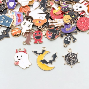 Detail of assorted enamel Halloween charms showing ghost, pumpkin and skull designs