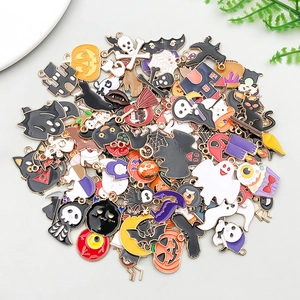 Close-up of colorful Halloween alloy pendants including pumpkins, ghosts and black cats