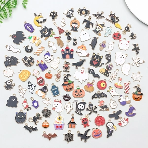 Flat lay of colorful enamel Halloween charms including pumpkins ghosts and bats for DIY jewelry