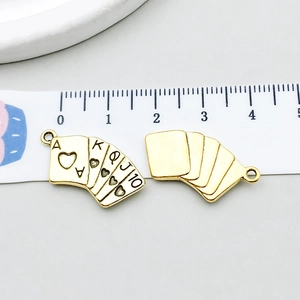 Macro shot of poker cards royal flush charms in antique gold finish for DIY jewelry