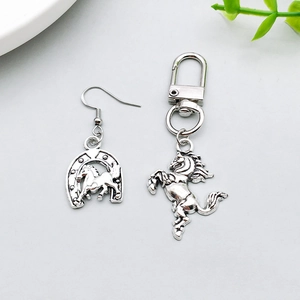 Detailed view of antique silver western horse earrings and keychain with S925 stamp