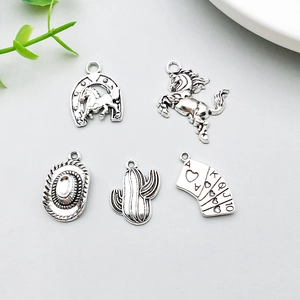 Detail view of five antique silver alloy cowboy charms for DIY jewelry making