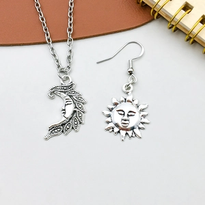 Nahaufnahme von Vintage Silber Mond und Sonne Anhängern mit böhmischen Gravurdetails