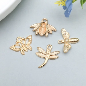 Detailed close-up of golden alloy insect pendants featuring butterfly bee and dragonfly