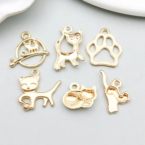 Detail of six golden cat-shaped alloy charms for DIY jewelry and necklaces