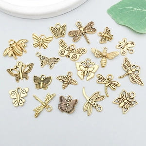Macro detail of antique gold insect pendants including butterflies, bees and dragonflies