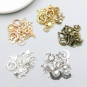Macro view of assorted celestial alloy charms in five metallic finishes for DIY jewelry