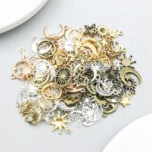 Detailed close-up of mixed alloy sun, moon, and star pendants for DIY jewelry crafting