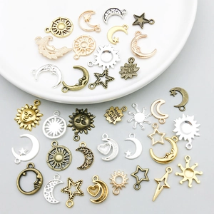 Detailed close-up of alloy sun moon and star charms with Made with a smile engraving